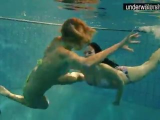 Two captivating amateurs showing their bodies off under water