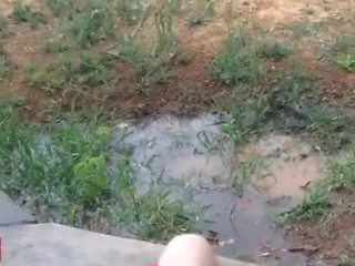 A little 18 years old mistress plays with a hose outdoors in public